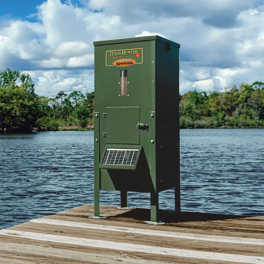 Texas Hunter straight-leg fish feeder with solar panel on a dock